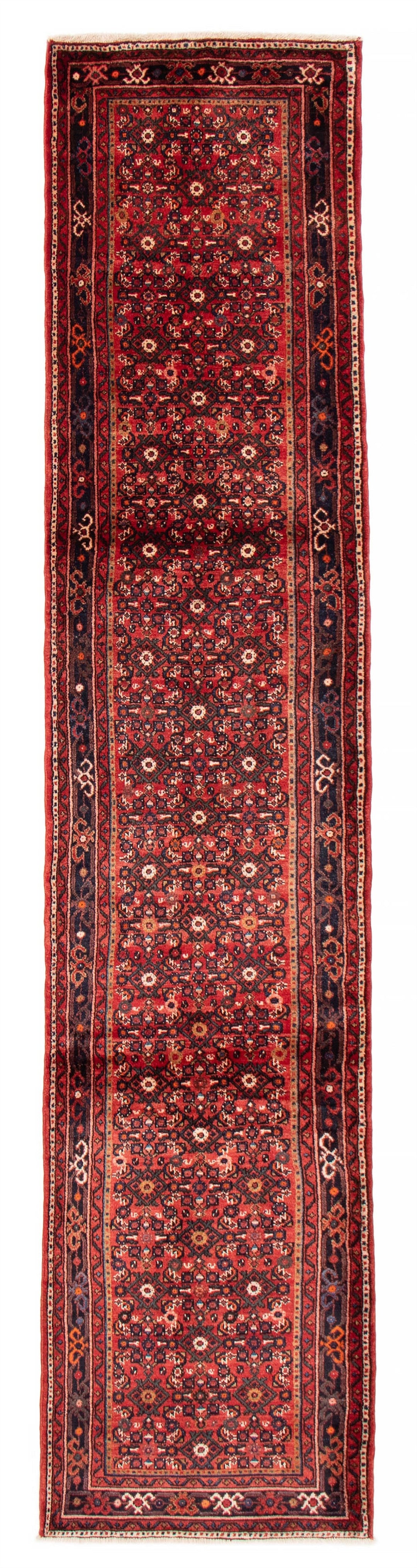 The Crown hand-knotted Iranian wool runner featuring intricate geometric patterns in deep red, black, and cream tones. Available at Tuck Rugs.