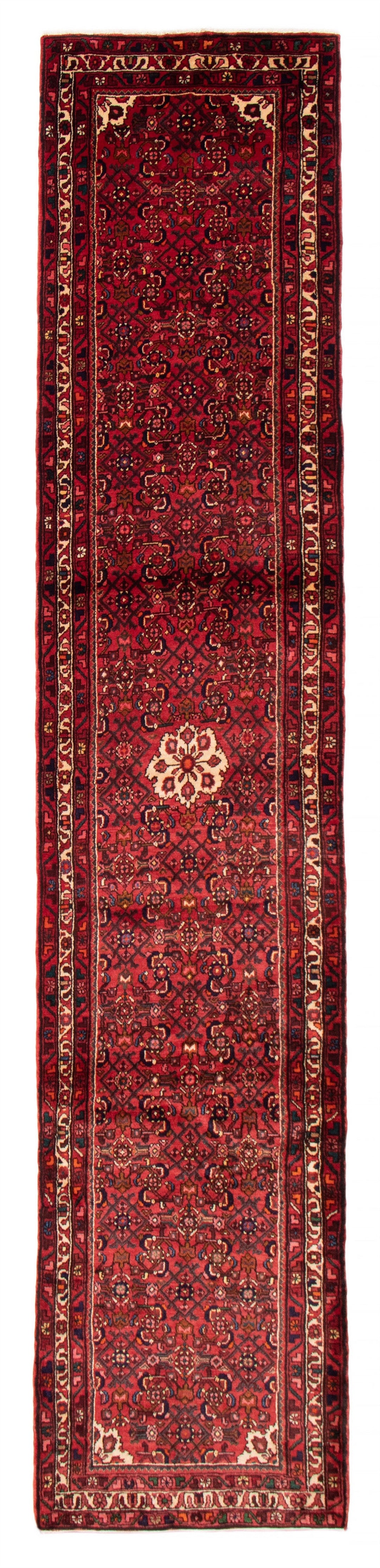 The Falls hand-knotted Iranian wool runner featuring geometric patterns in deep red and navy tones. Available at Tuck Rugs.