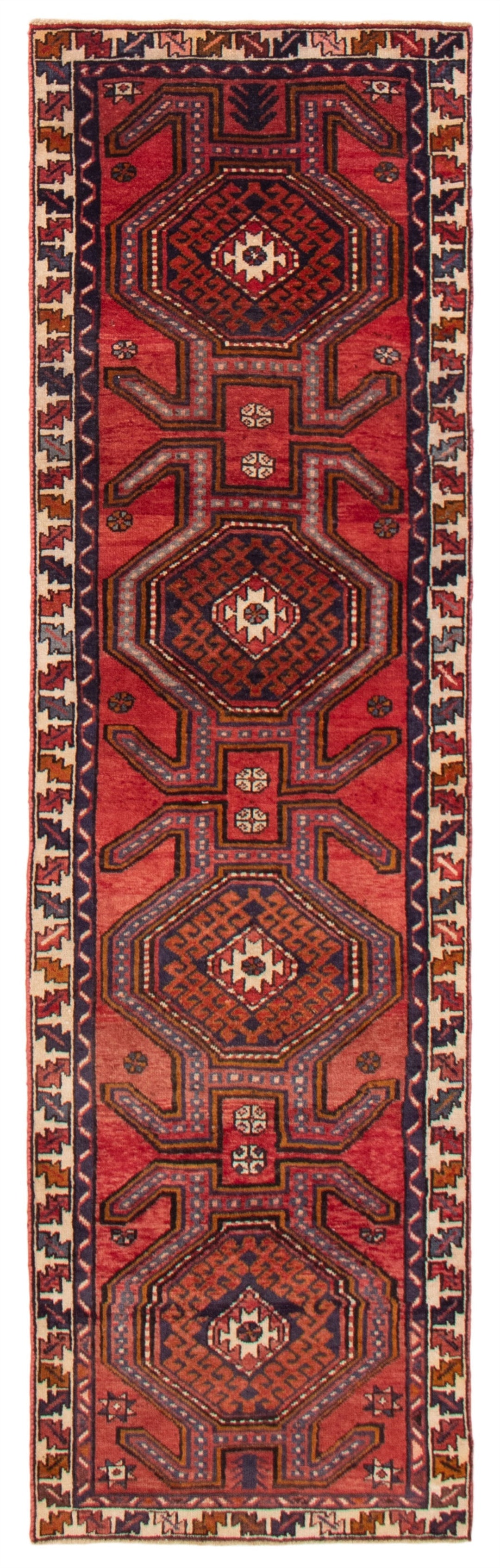 A hand-knotted Turkish wool runner featuring geometric hexagonal patterns in deep reds and blues. Available at Tuck Rugs.