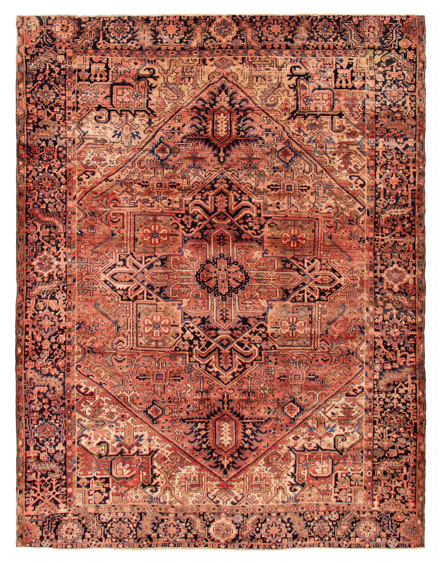 Hand-knotted Persian-style rug featuring bold Serapi geometric patterns in rich tones and soft hues, blending traditional and modern elements. Available at Tuck Rugs.