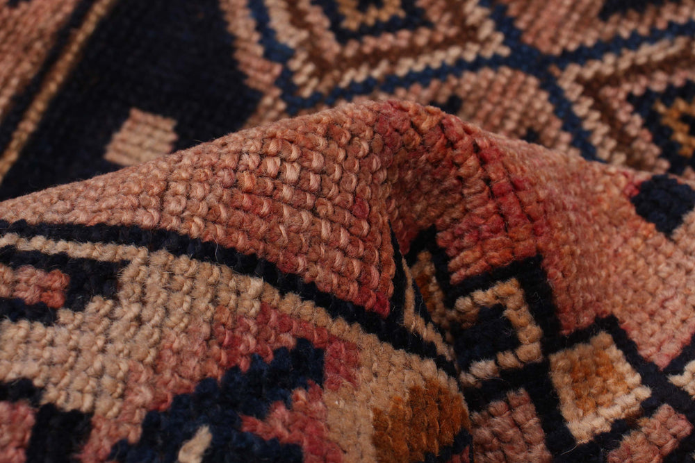 Close-up view of The Trinity Rug’s intricate geometric patterns and fine hand-knotted craftsmanship. Available at Tuck Rugs.