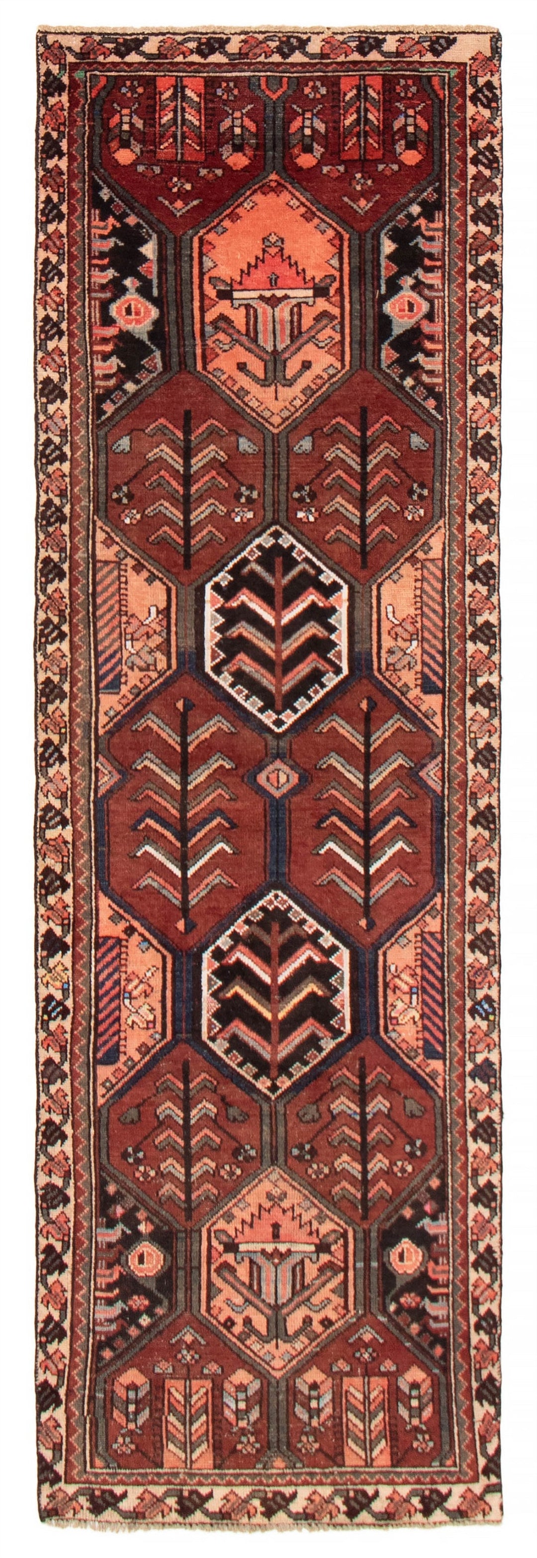 Turkish wool runner featuring bold geometric patterns with warm earth tones, including rich reds, oranges, and browns. The runner is hand-knotted with detailed motifs, available at Tuck Rugs.