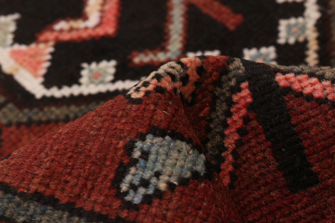 Close-up view of the intricate weave of the Turkish wool runner, highlighting the texture and craftsmanship of the design, showcasing a mix of earthy tones.