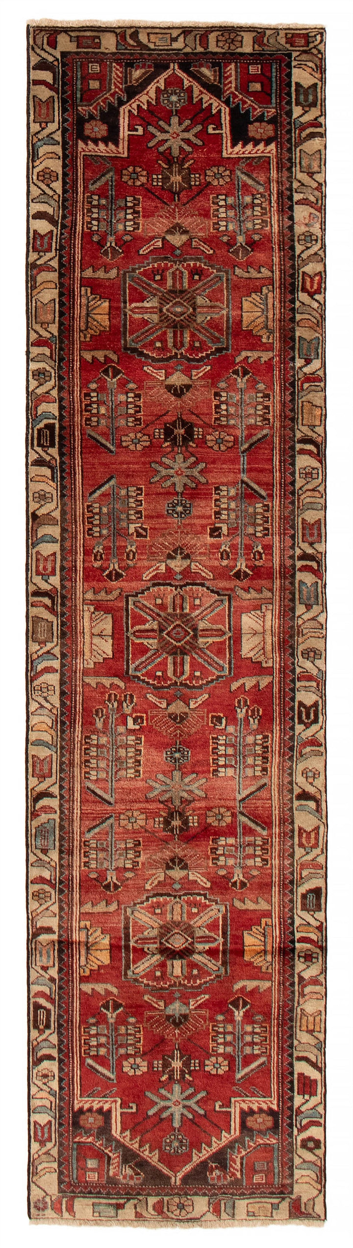 Full-length view of the Turkish wool runner featuring intricate geometric patterns in rich, warm hues of red, available at Tuck Rugs.