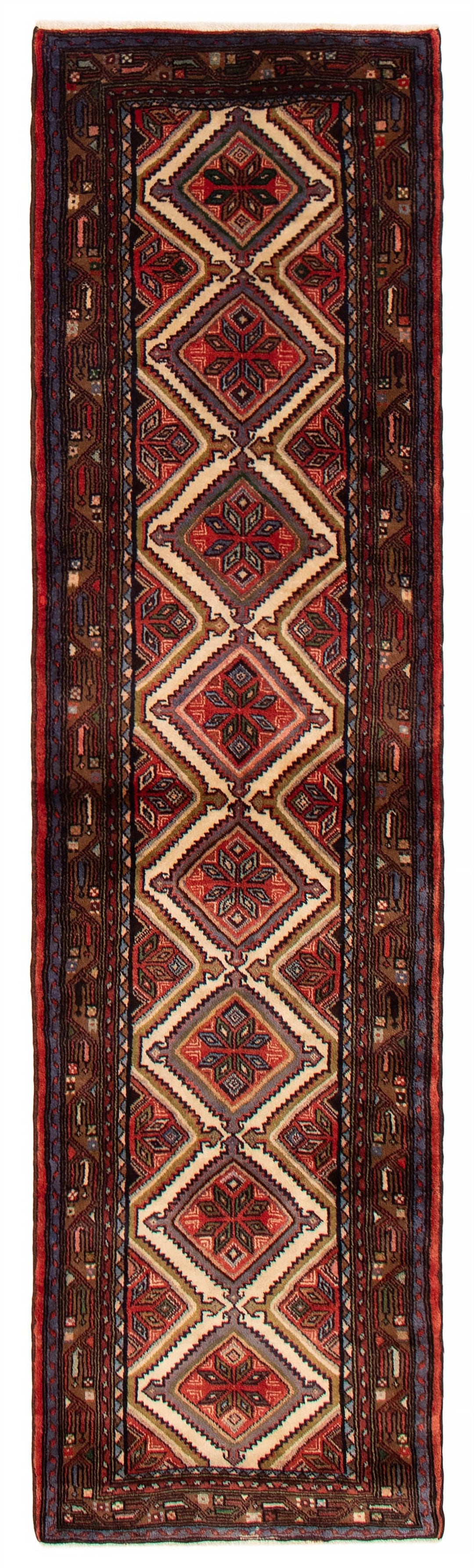 A hand-knotted Turkish wool runner featuring diamond-shaped geometric patterns in rich red and beige tones. Available at Tuck Rugs.