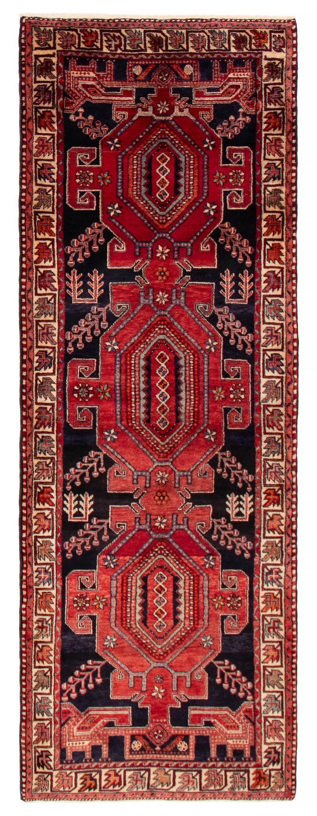 The Latimore Turkish wool runner, 3'0" x 10'0", featuring intricate geometric patterns in beige, brown, and blue tones, displayed in a long hallway. Available at Tuck Rugs.