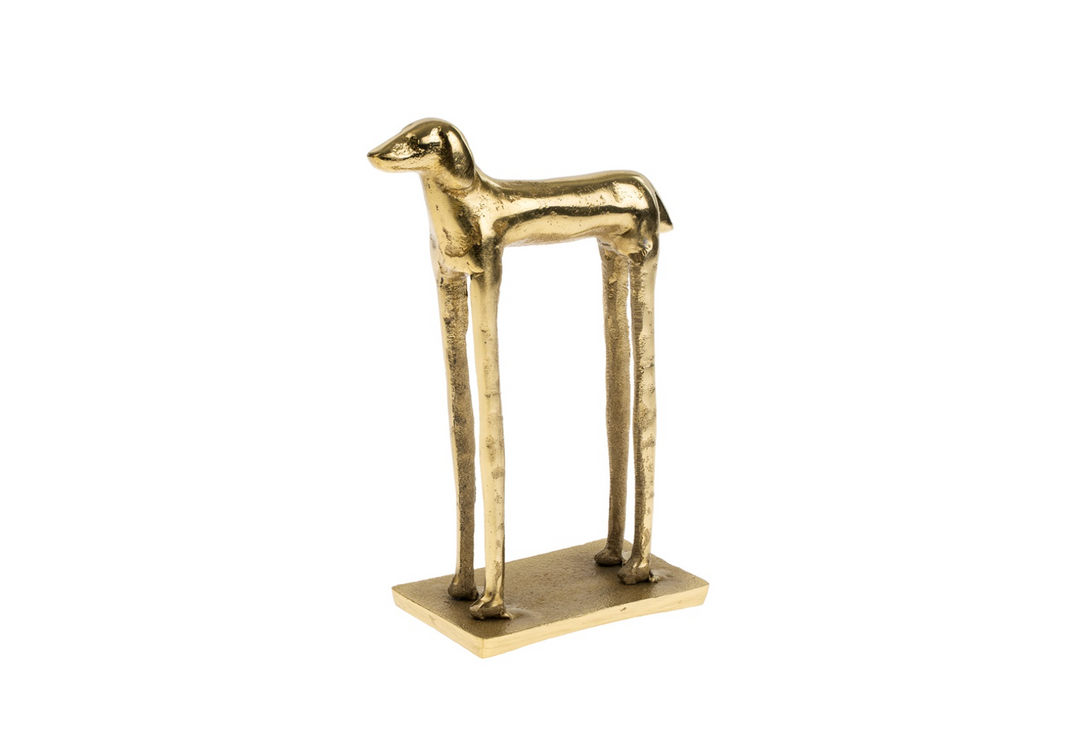 Gold-colored dog sculpture on a white background