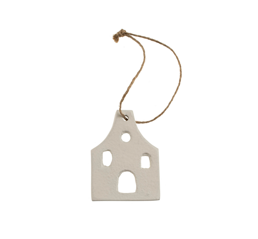 Decorative house-shaped ornament with a string on a white background