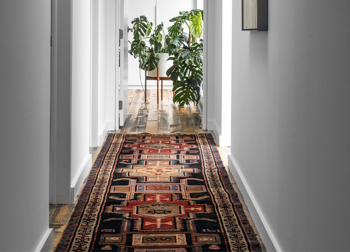 The Leinster Rug displayed in a hallway, adding warmth and character with its detailed geometric designs. Available at Tuck Rugs.