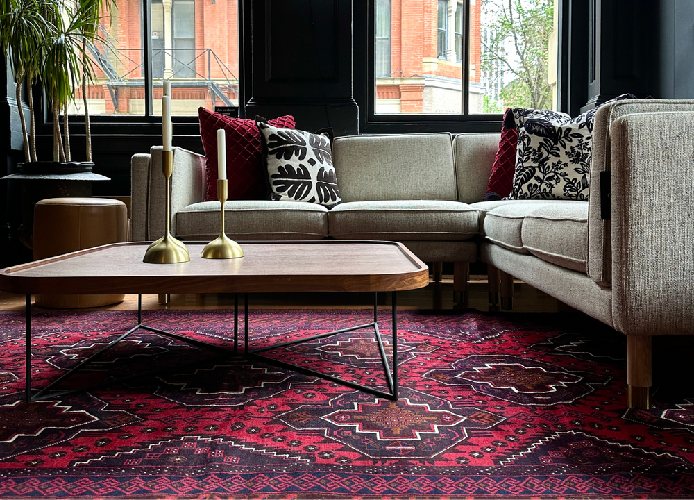 The Douglas rug styled in a living room, showcasing its bold geometric patterns in rich colors. Available at Tuck Rugs.