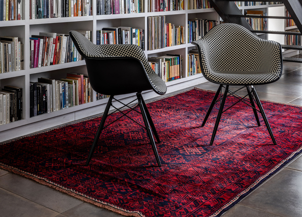 The King’s Square Afghan wool rug styled in a cozy reading nook, adding warmth and texture to the space. Available at Tuck Rugs.