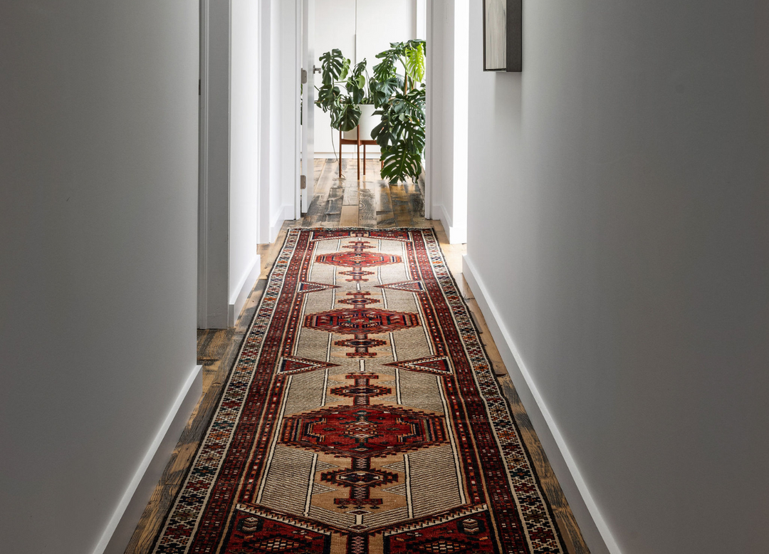 The Port City Rug displayed in a hallway, adding warmth and color with its bold geometric designs. Available at Tuck Rugs.