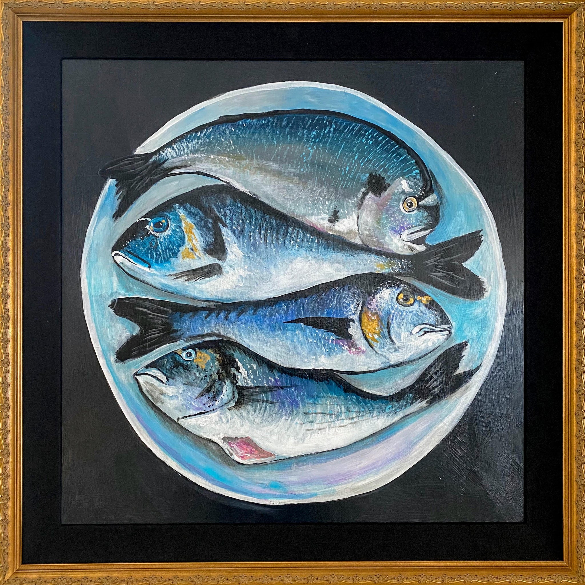 Four fish on a white plate